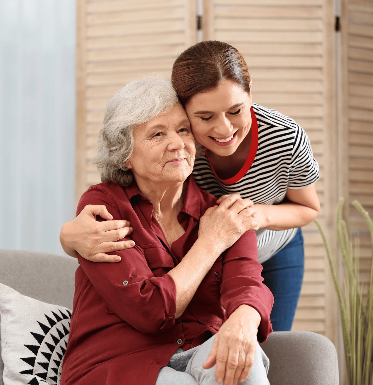 A carer and someone they support sharing a warm moment together at home